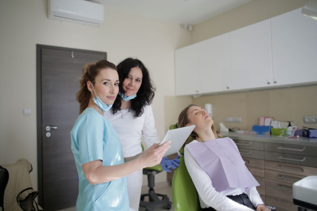 Dental professionals discussing care with a tablet in a clinic